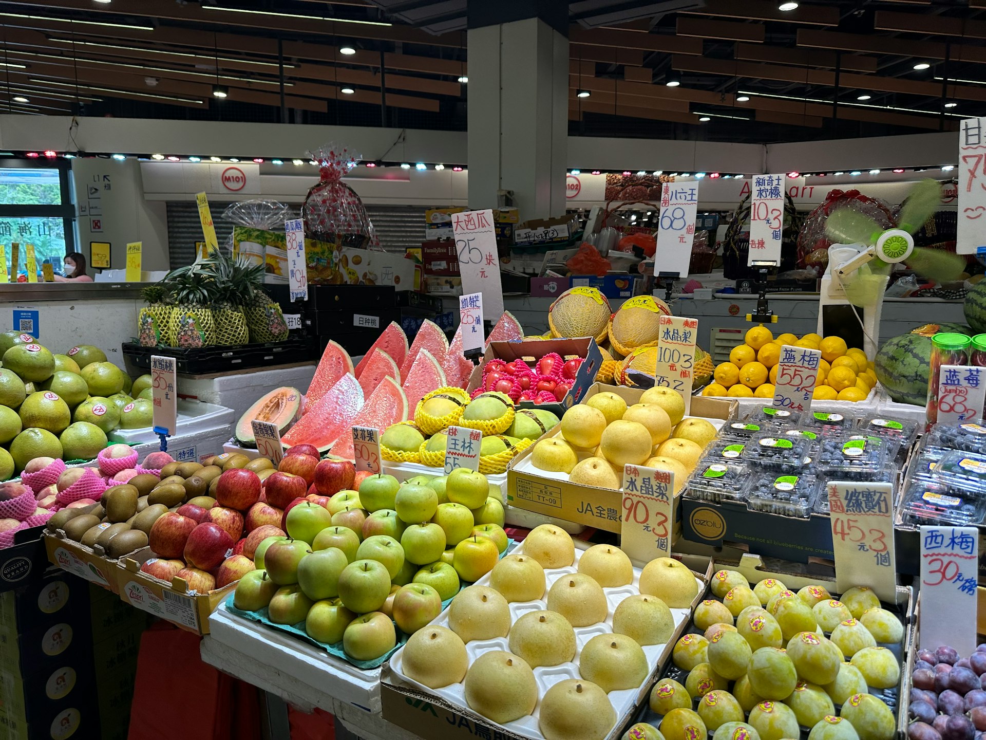 a fruit stand with a variety of fruits on display